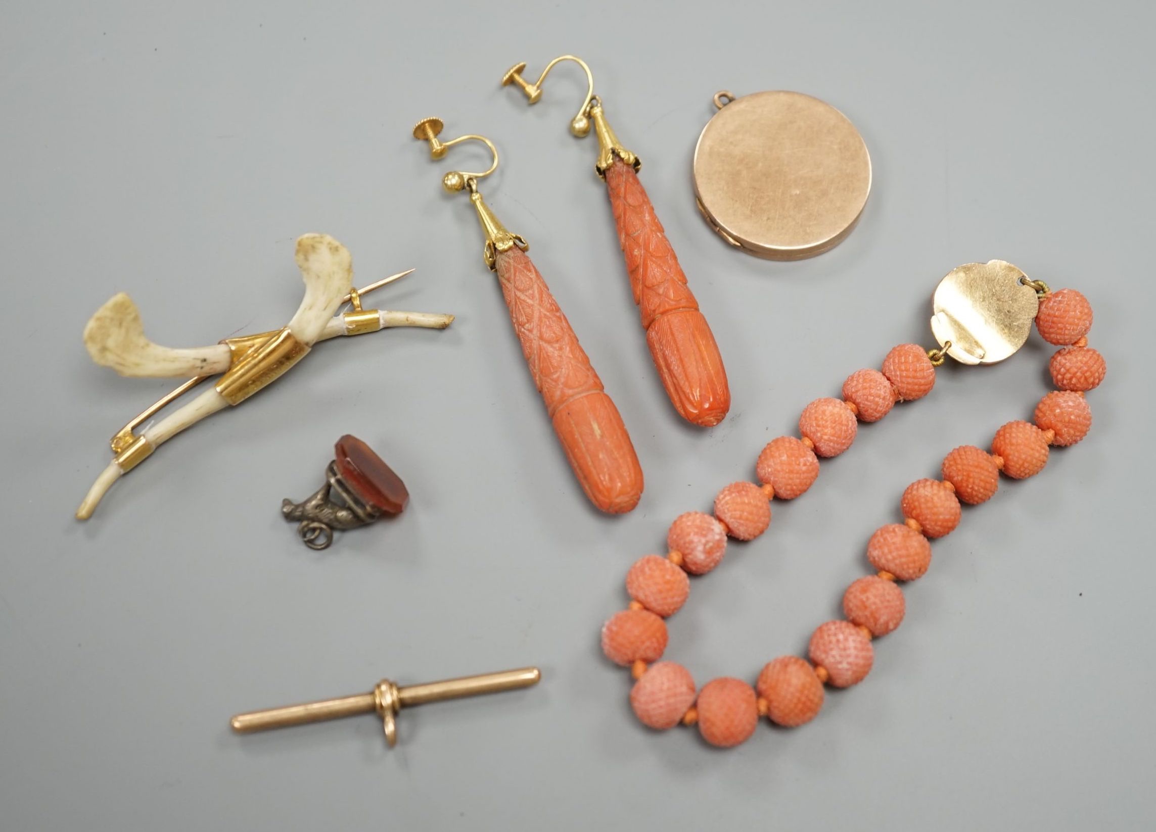 A pair of 9ct mounted teardrop shaped carved coral drop earrings, 6cm, gross 14.7 grams, a carved coral bead bracelet with yellow metal and carved coral bust set clasp, gross 20.5 grams and four other items including a 9